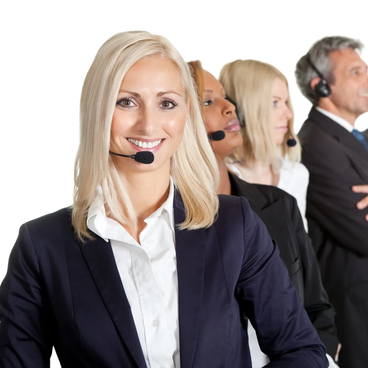 A row of four customer service representatives wearing headsets, with a woman in the foreground smiling at the camera.